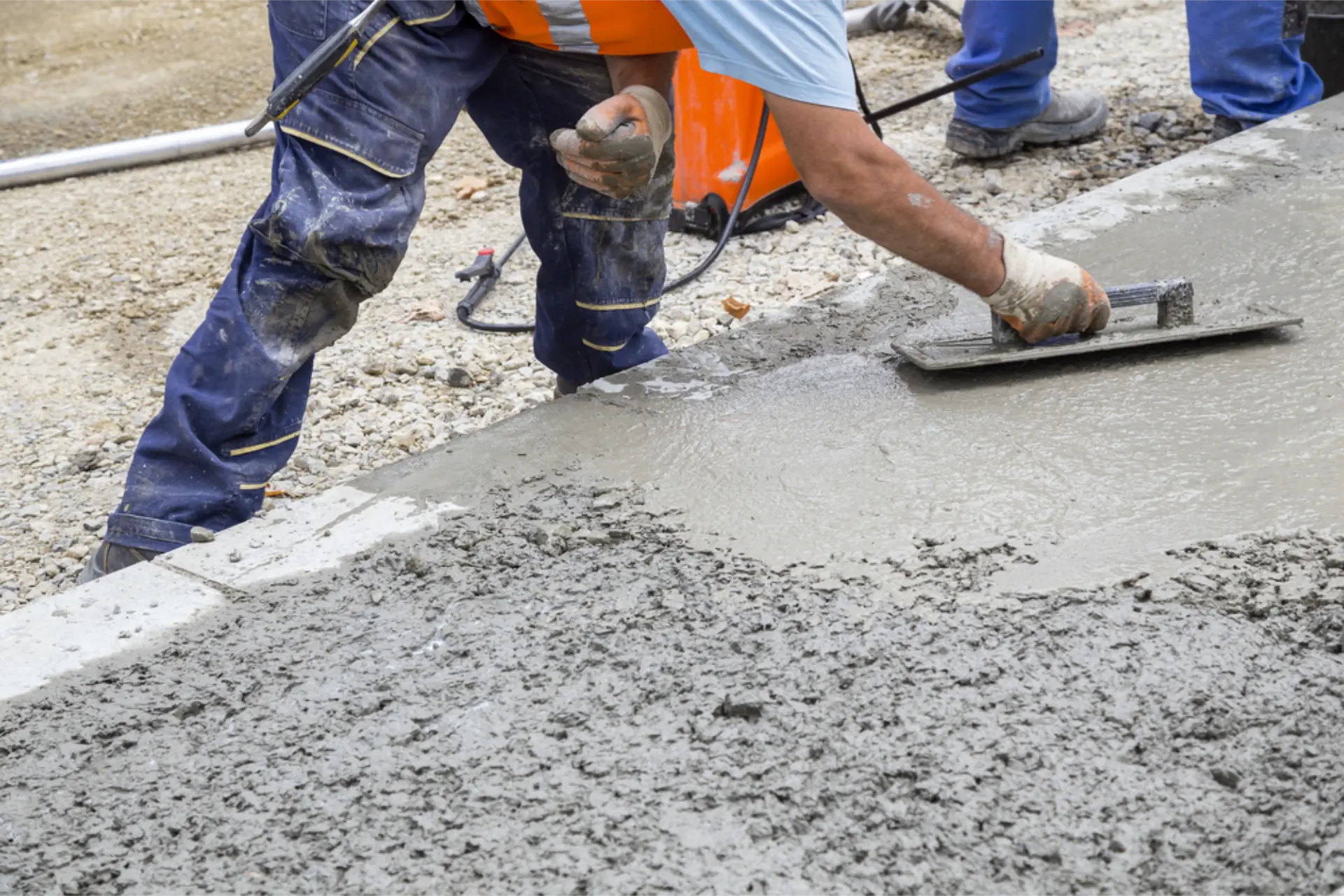A trowel finishing the curb edge of a new concrete pour