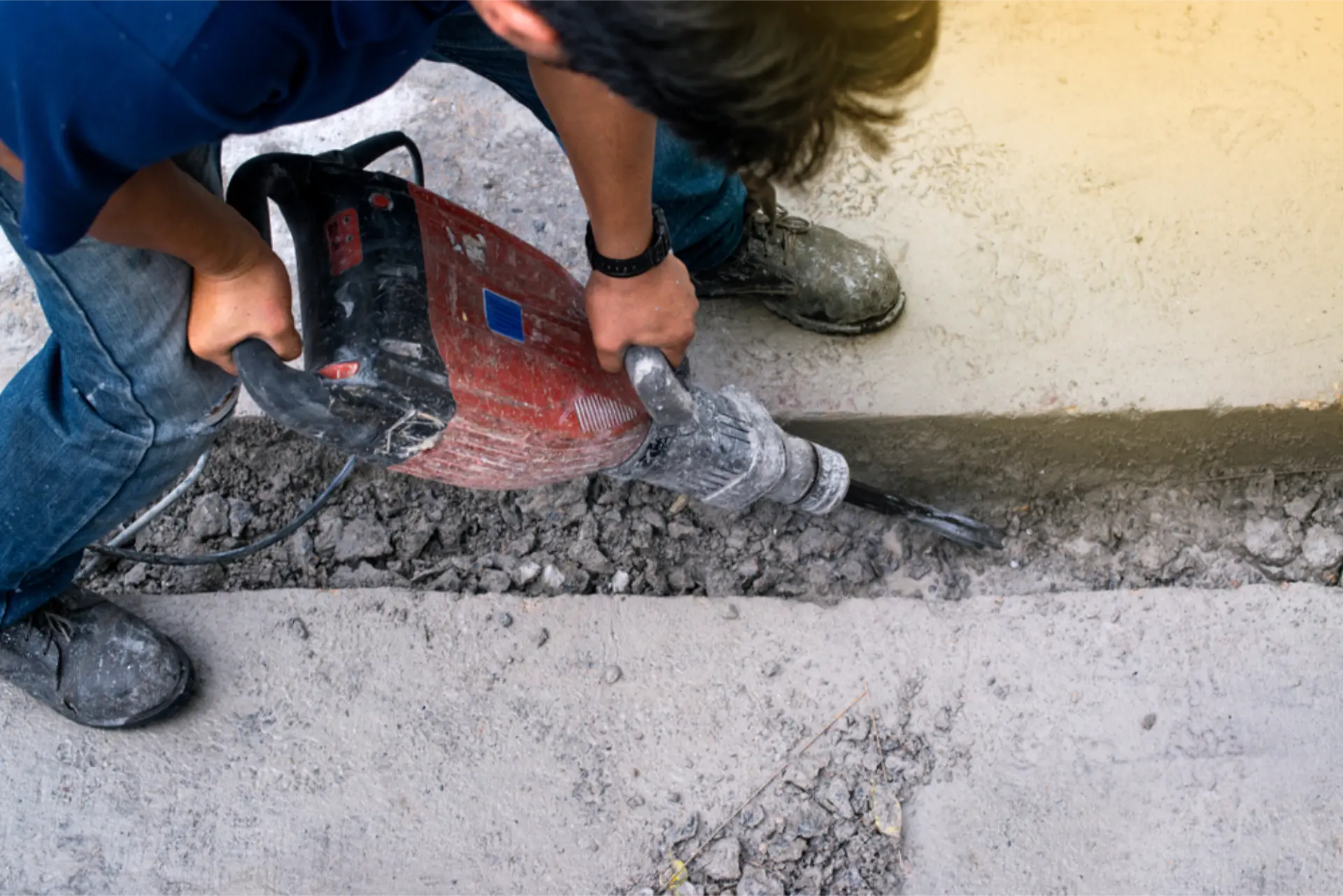 Old concrete being broken out with a jackhammer ready for removal
