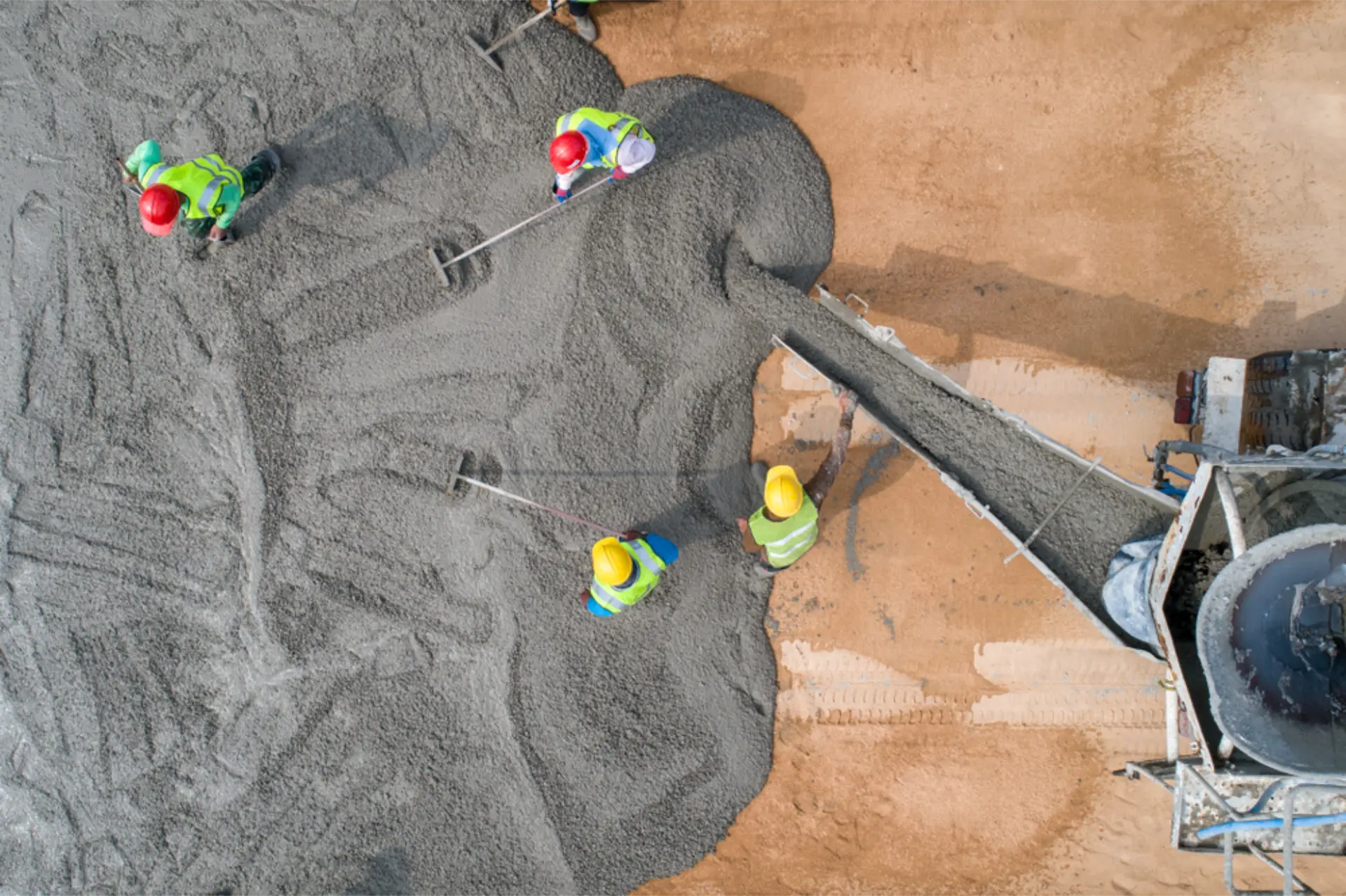 Aerial view of a crew placing concrete with a pump truck during a slab pour